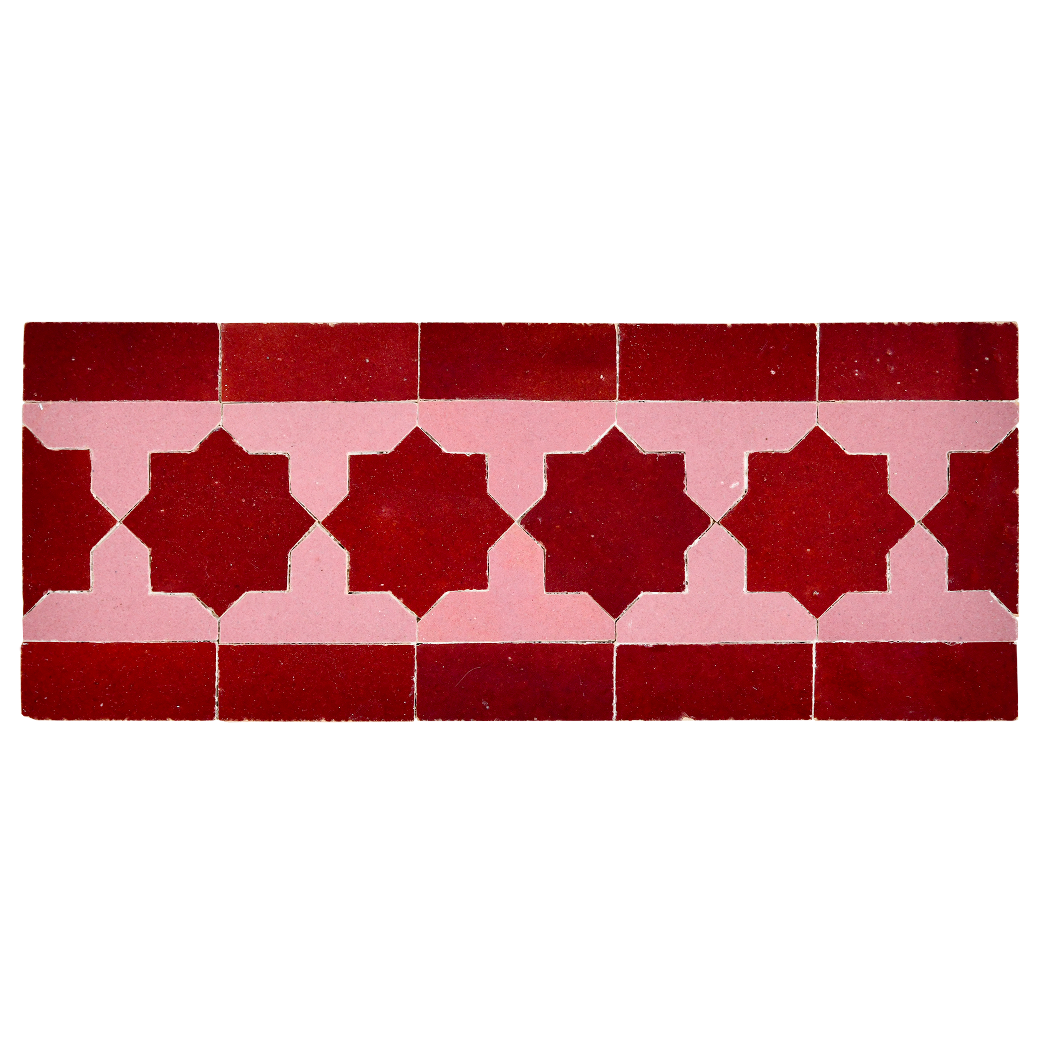 Red and pink decorative tiles with geometric pattern on a white background