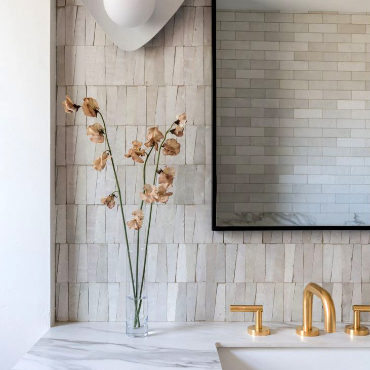 Cream zellige trapezoid mosaic tile close-up showing handmade glaze texture