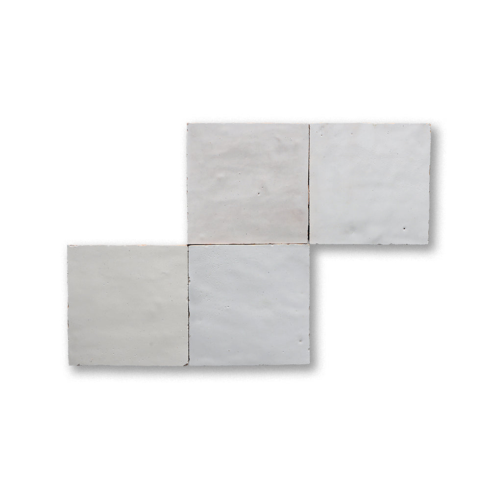 Set of four gray concrete tiles on a white background
