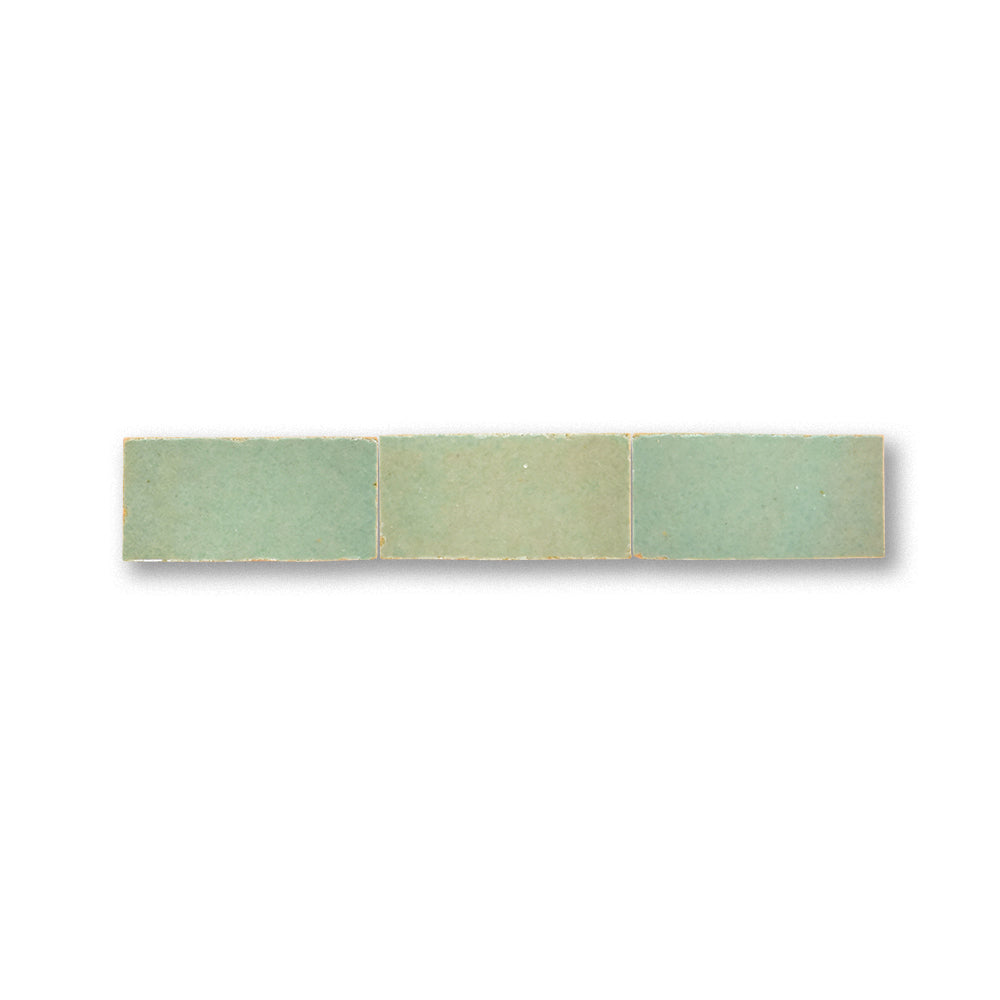 Rectangular tile with three green color swatches on a white background