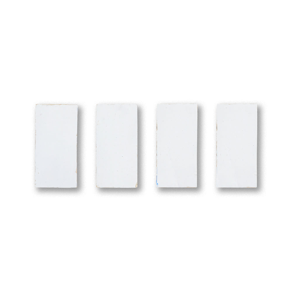 Four white rectangular light switches on a white background