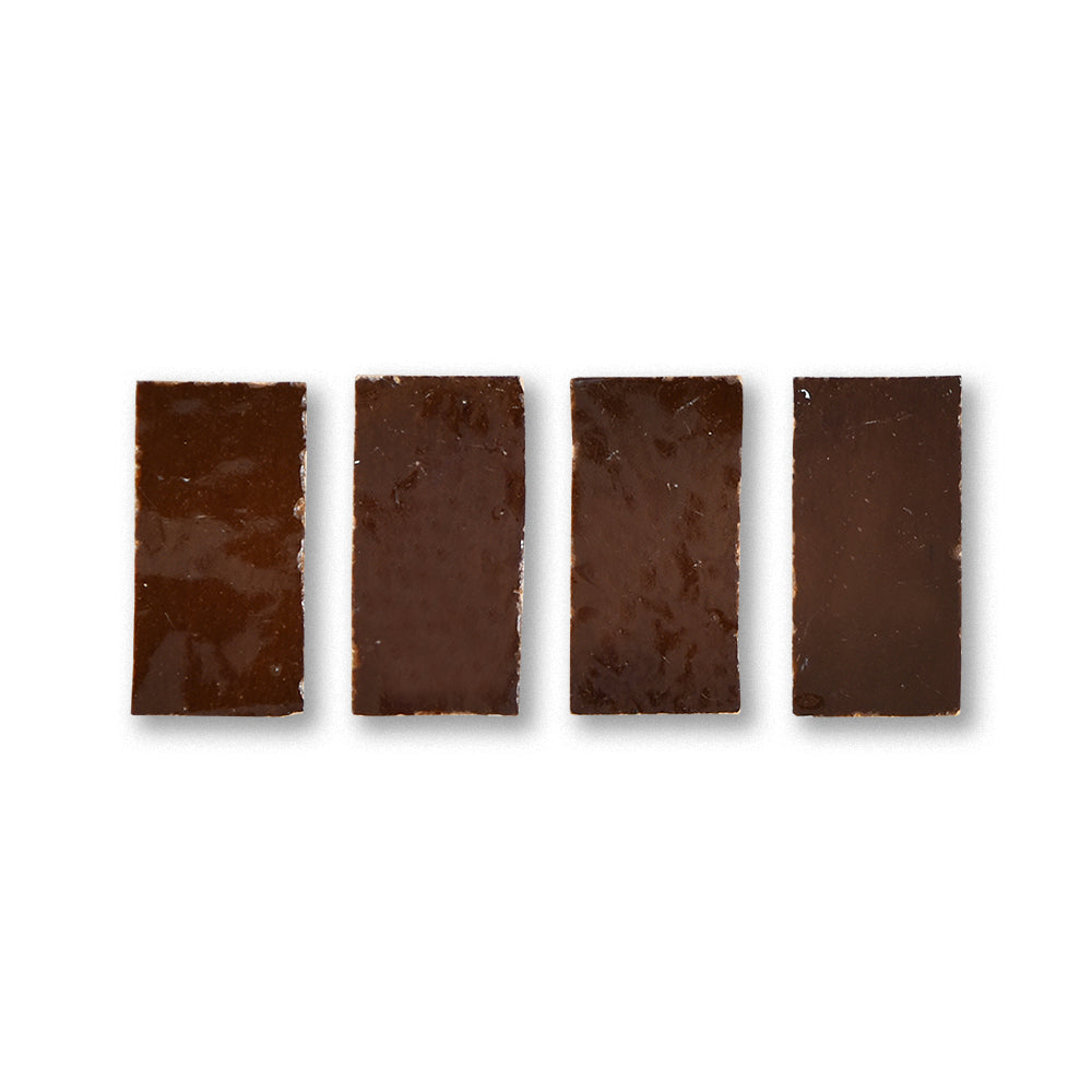 Four dark chocolate bars arranged in a row on a white background
