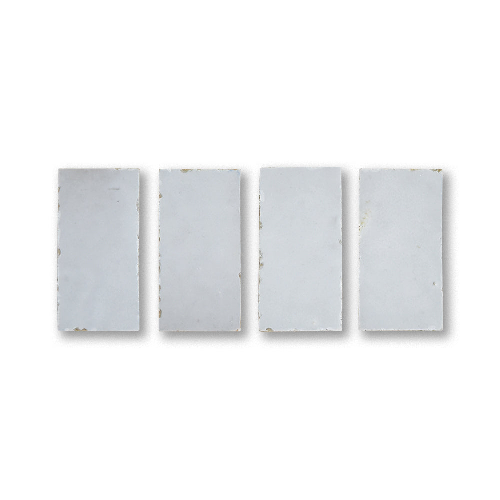 Four rectangular tiles with a subtle pattern on a white background