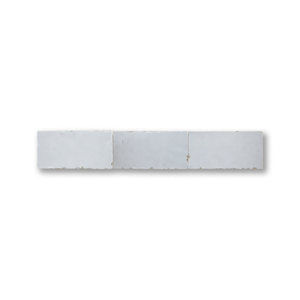 Three white tiles arranged in a row on a white background