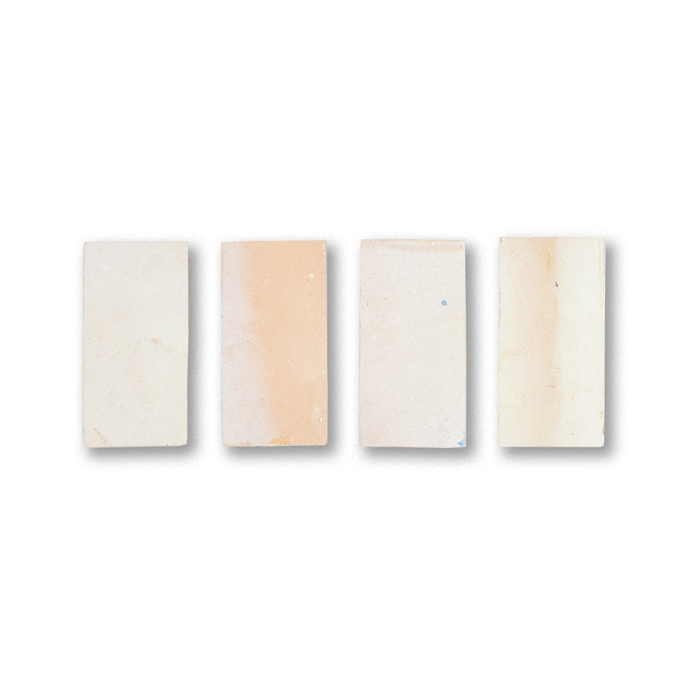 Four rectangular wooden samples with different finishes on a white background