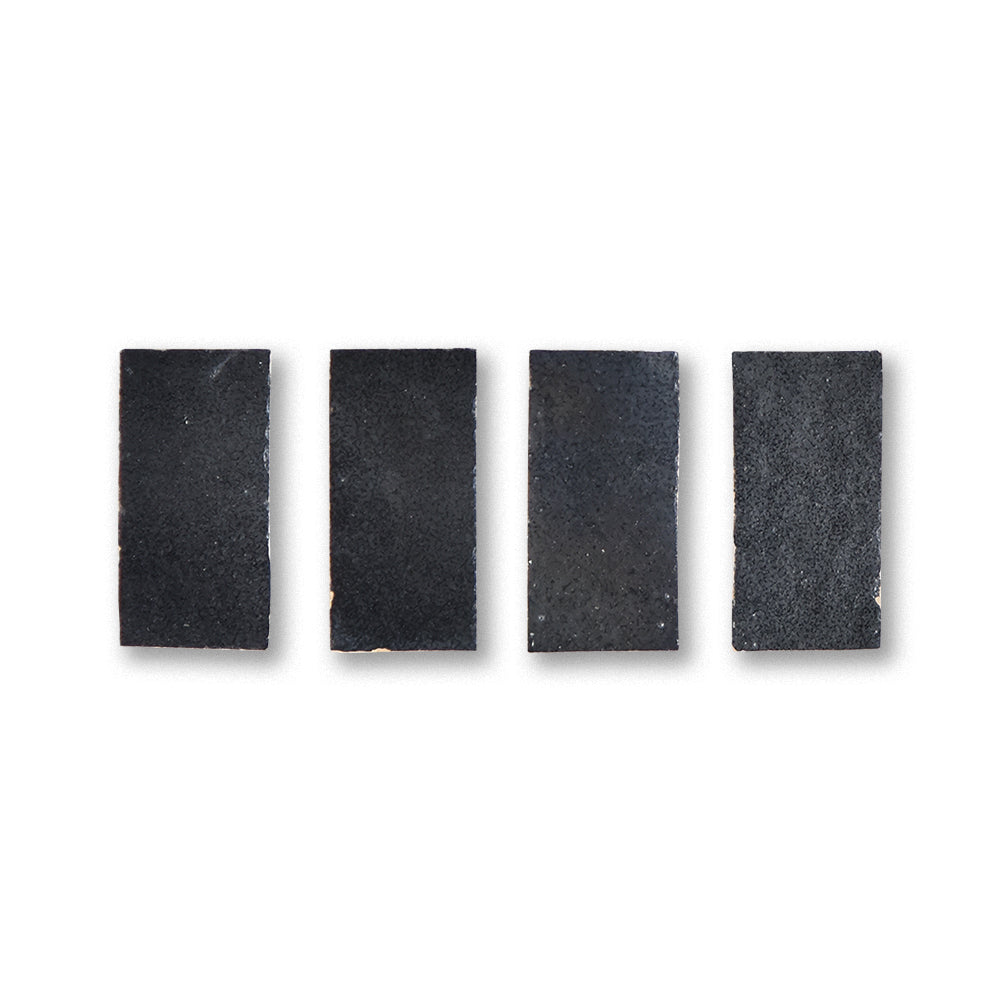 Five black rectangular foam pads on a white background