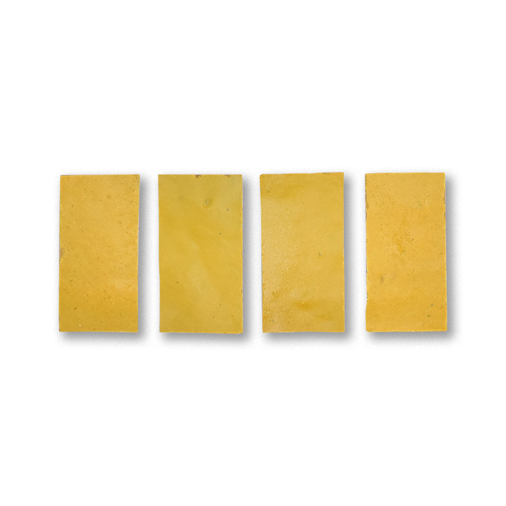 Four rectangular yellow soap bars on a white background