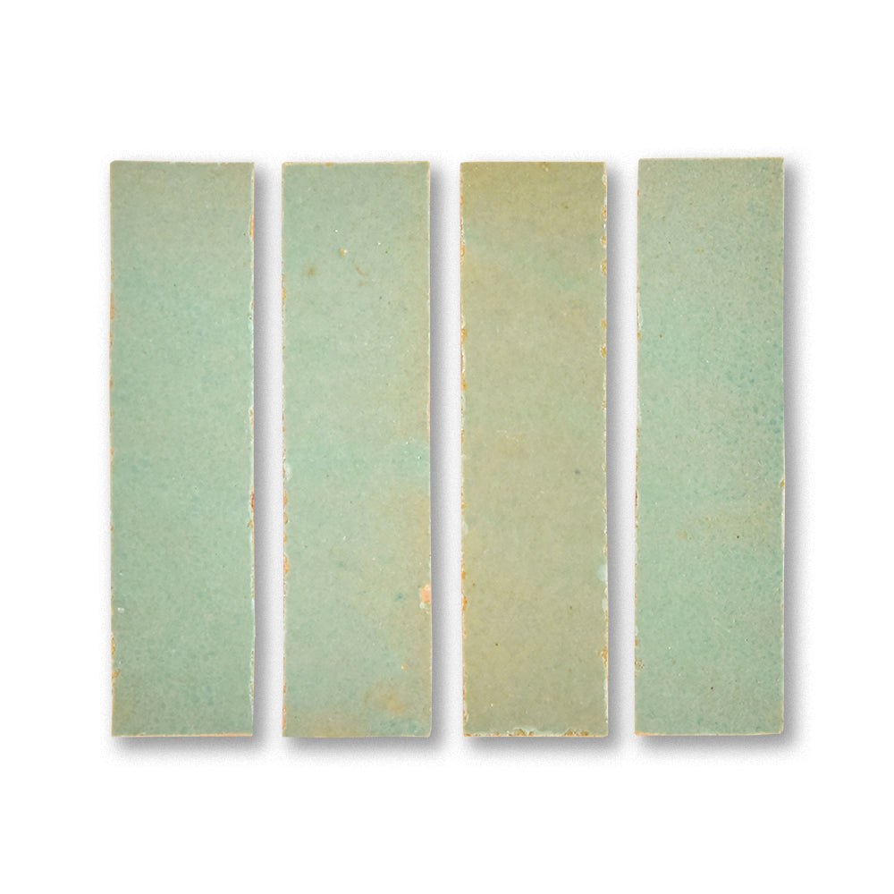 Set of four rectangular ceramic tiles with a gradient green color on a white background