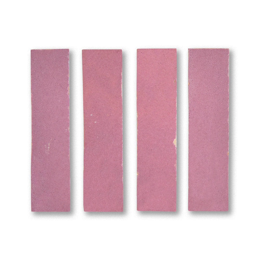 Four pink sandpaper sheets of different grits on a white background